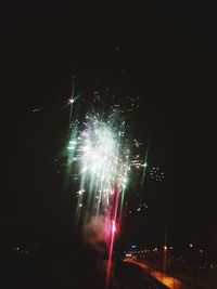 Low angle view of firework display at night