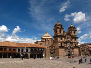 View of the cusco cathedral and the square against cloudy sky