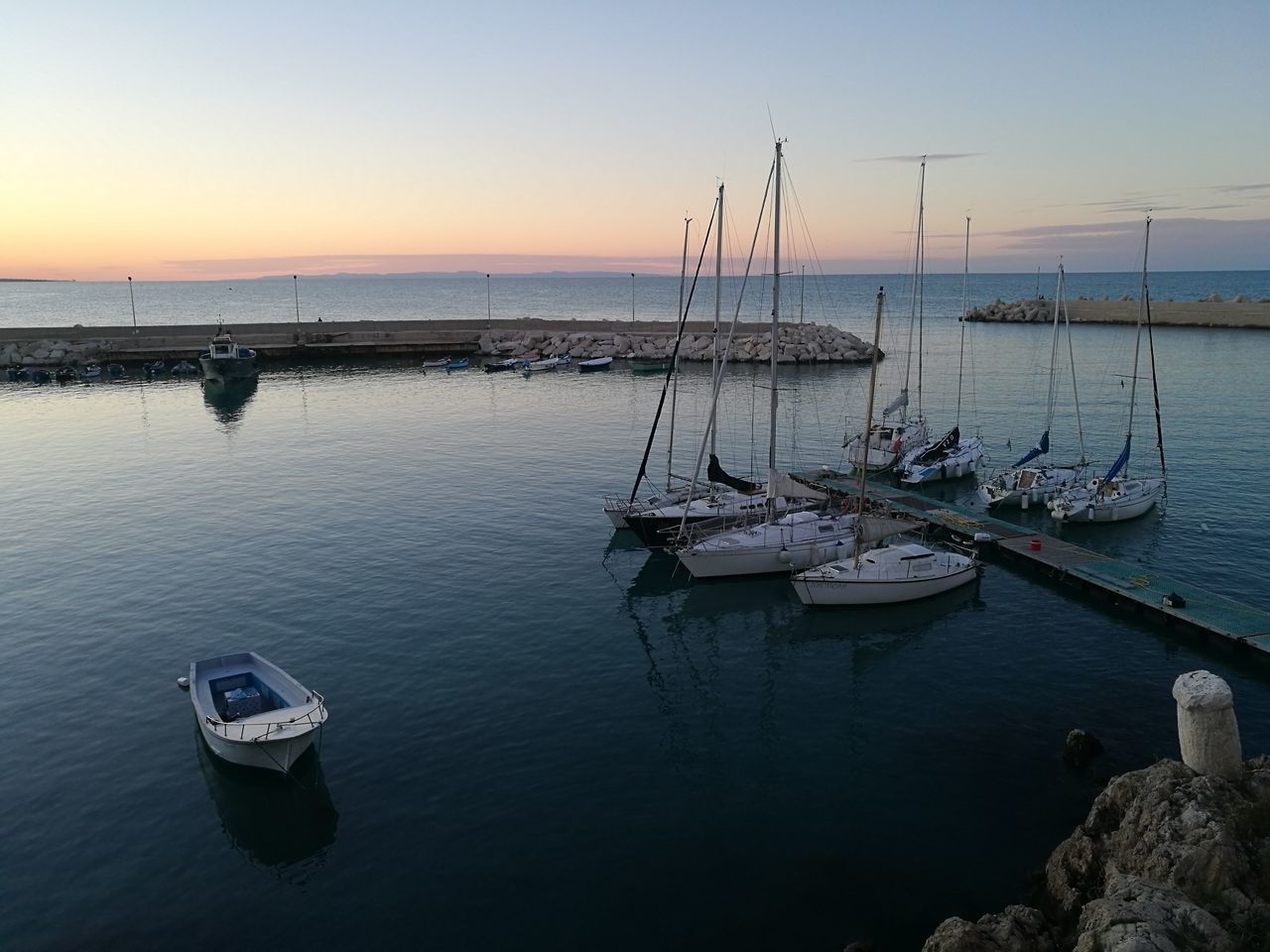 SAILBOATS MOORED ON SEA AGAINST SKY