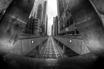 Low angle view of railroad tracks amidst buildings in city