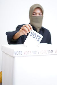 Full length of young man standing against white background