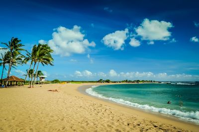 Scenic view of beach against blue sky