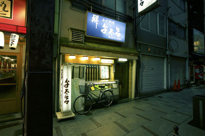 Bicycle parked in city at night