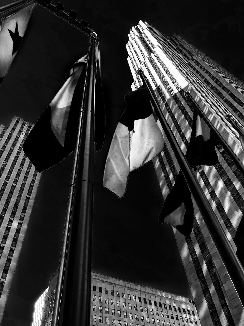 LOW ANGLE VIEW OF FLAGS HANGING ON BUILDING