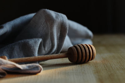 Close-up of honey stirrer and napkin on table