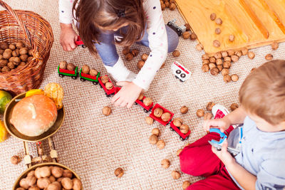 High angle view of girl sitting on table