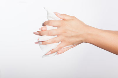 Close-up of woman hand against white background
