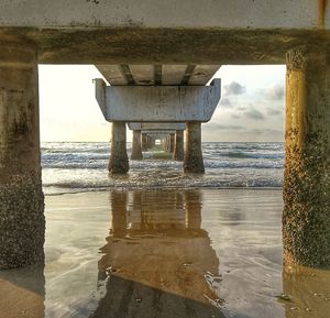 Scenic view of sea against sky seen through archway