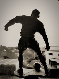 Man with ball against clear sky