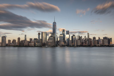 Modern buildings in city against cloudy sky