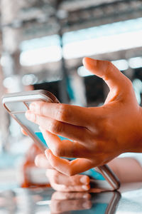 Close-up of hand using mobile phone