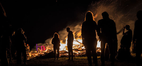 Group of people against sky at night