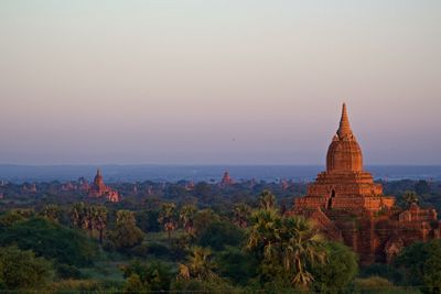 Scenic view of temples against clear sky during sunset