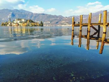 Scenic view of lake orta against sky.  san giulio island. february.