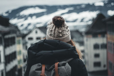 Rear view of woman standing in snow