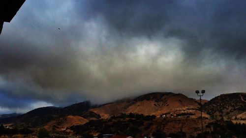 Scenic view of mountains against cloudy sky