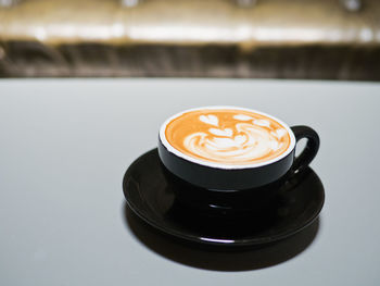 Close-up of cappuccino on table