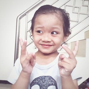 Cute girl gesturing at home