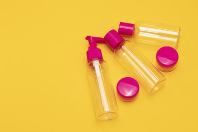 High angle view of beauty products on yellow background