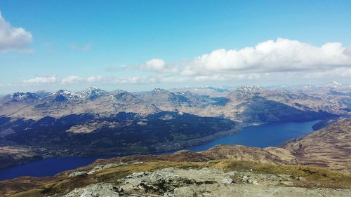 Scenic view of mountains against cloudy sky