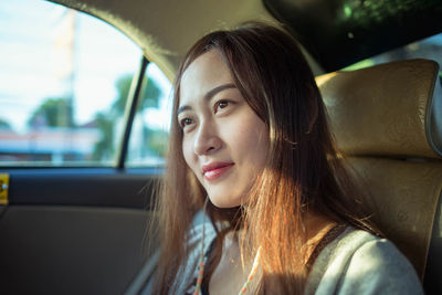 Close-up of young woman in car