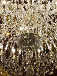 Close-up of illuminated chandelier hanging on ceiling