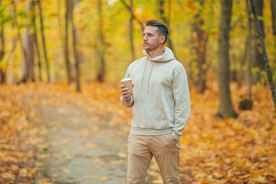 Man standing in forest during autumn