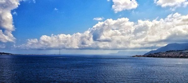 Panoramic view of sea against blue sky