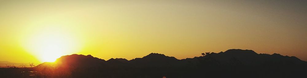 Scenic view of silhouette mountains against sky during sunset