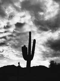 Silhouette of cactus plant against cloudy sky