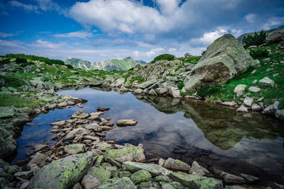 Scenic view of lake and mountains against sky
