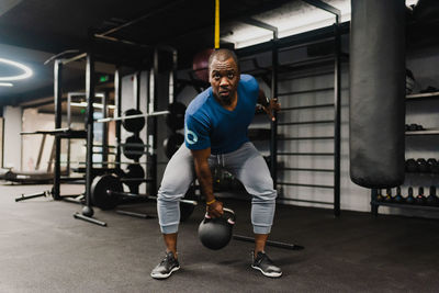 Side view of man exercising in gym