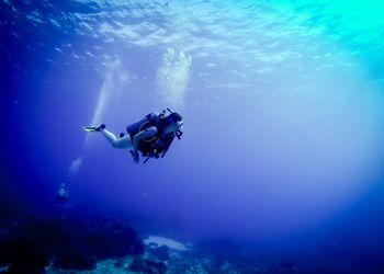 Woman scuba diving in sea