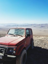 Scenic view of desert against clear blue sky