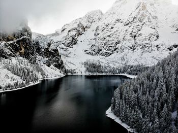 Scenic view of snowcapped mountains and lake during winter