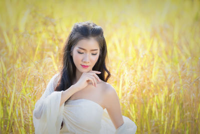 Beautiful young woman in field