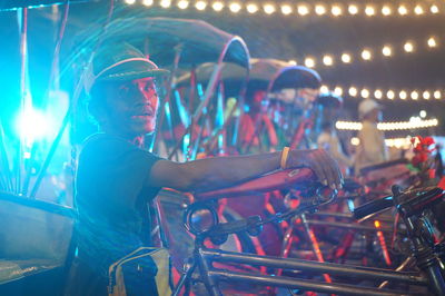 People on illuminated bicycle at night