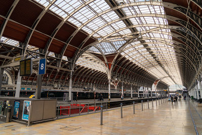 Inside large london train station glass and steel roof