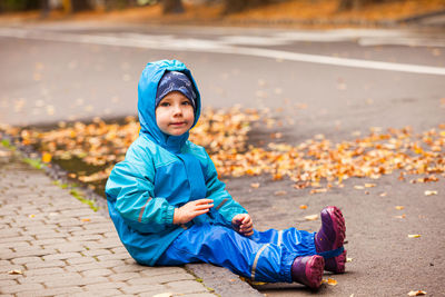 Portrait of boy sitting outdoors