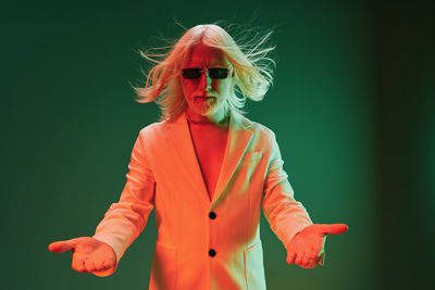 Young woman standing against black background