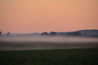 Scenic view of field against sky during sunset