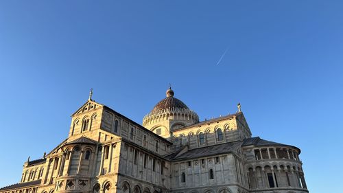 Low angle view of historic building against blue sky