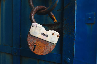 Close-up of padlock on blue door