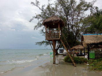 Lifeguard hut at beach against sky