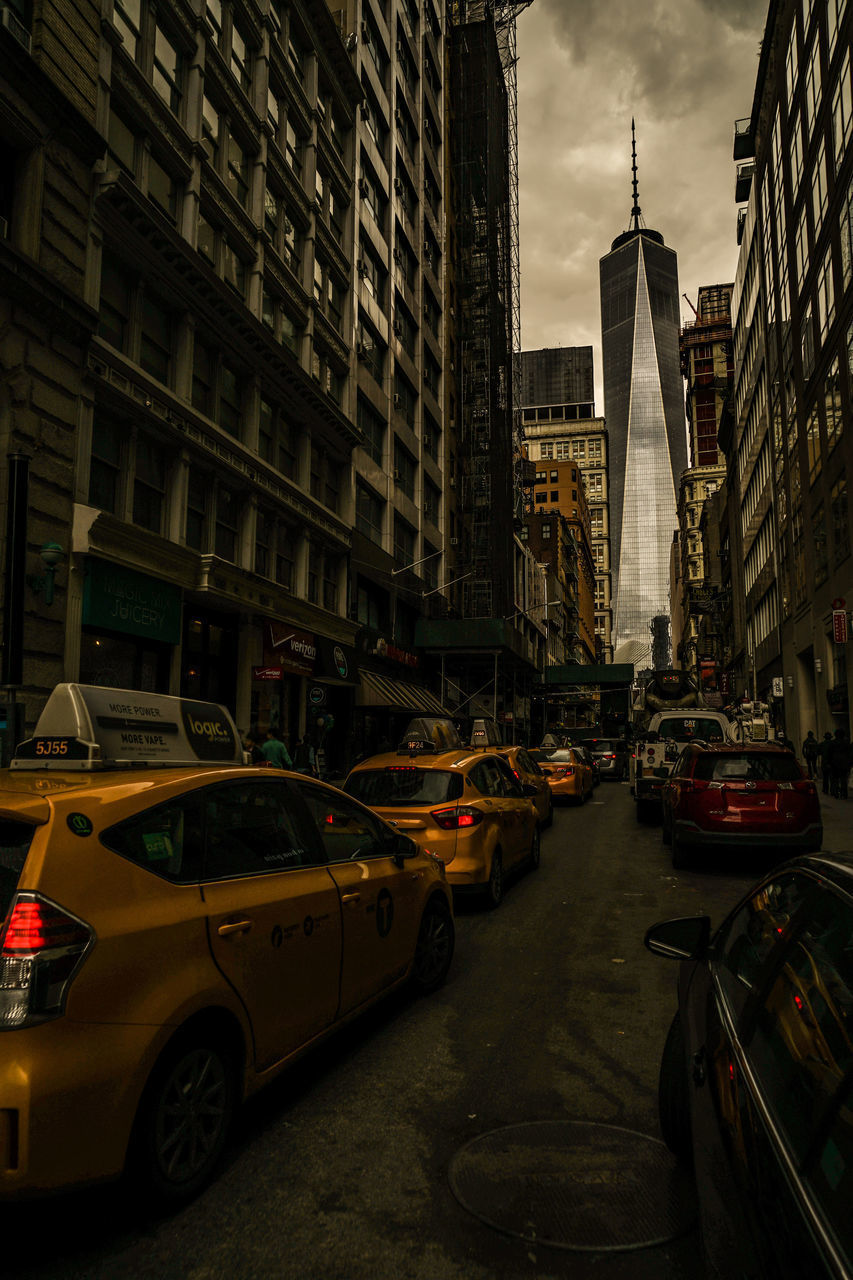 TRAFFIC ON CITY STREET AMIDST BUILDINGS