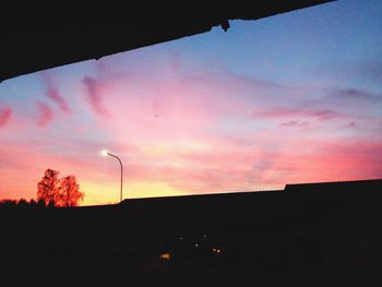 Low angle view of silhouette trees against sky at sunset