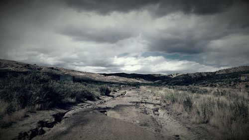 Scenic view of mountains against cloudy sky