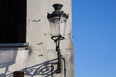 Low angle view of street light against building