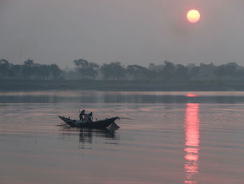 Scenic view of lake against sky during sunrise 