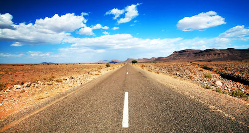 Road amidst landscape against sky